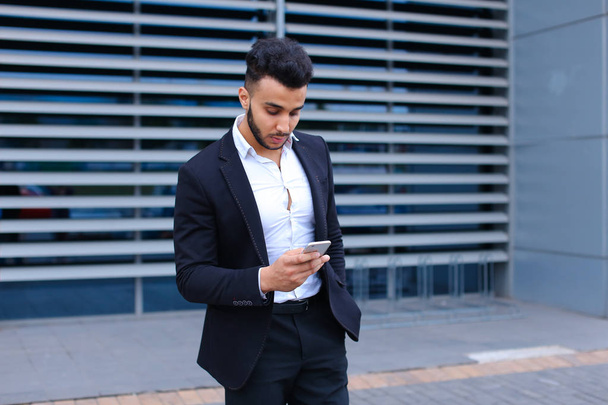 Jeune homme arabe utilise le centre d'affaires de téléphone intelligent mobile
 - Photo, image