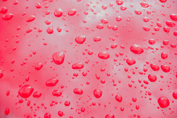 Rain drops on red background - Photo, Image