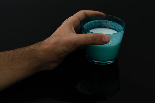 Man hand holding a glass of kefir - Photo, Image