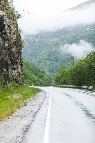 Foggy landscape with road in norwegian mountains - Fotoğraf, Görsel