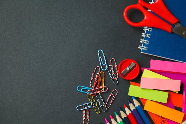 School and office supplies on dark background. Top view with copy space - Photo, Image