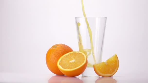Χύοντας χυμό πορτοκαλιού σε ποτήρι. - Πλάνα, βίντεο
