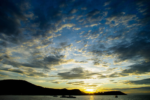 Nice dramatic sky with boat and island silhouette - Фото, зображення