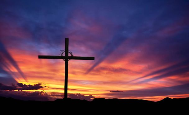 Cross silhouette on the mountain at sunset - Photo, Image