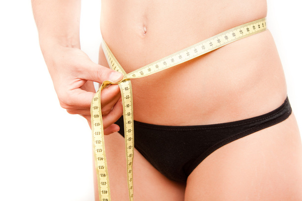 Giovane donna misurare il suo stomaco
 - Foto, immagini