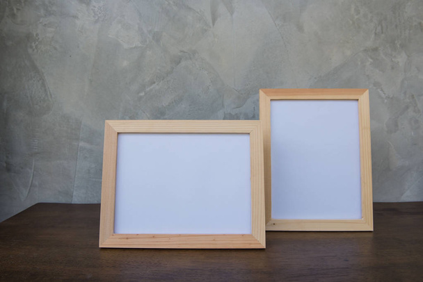 Two photo Frame on a wooden on Gray wall background . - Fotó, kép