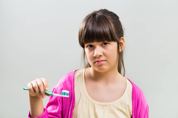 Sad little girl with toothbrush  - Fotoğraf, Görsel