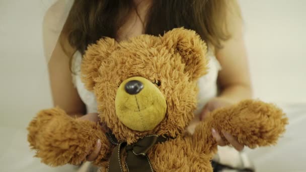 young woman with teddy bear - Filmati, video