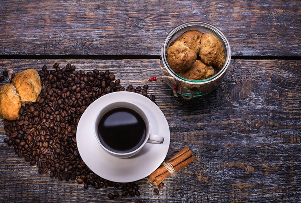 Coffee cup, coffee beans and biscuits, cookies  on wooden background - Photo, Image