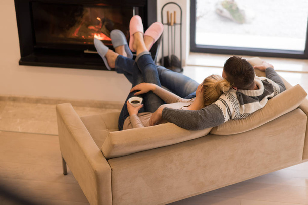 Young couple  in front of fireplace - Fotoğraf, Görsel