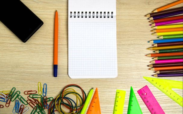 School supplies (pencil, pen, ruler, triangle) on blackboard bac - Photo, image