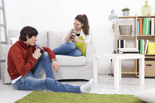 Teenagers in living room drinking juice - Photo, Image