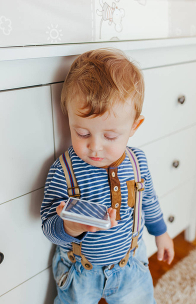 boy standing and using smartphone - Photo, Image
