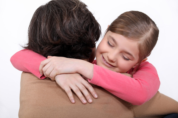 A mother hugging her daughter. - Φωτογραφία, εικόνα