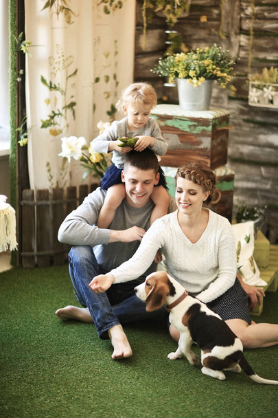 Portrait of happy family with their pet at home - Foto, afbeelding