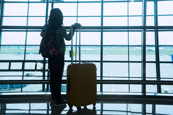 Silhouette girl standing in airport - Photo, image