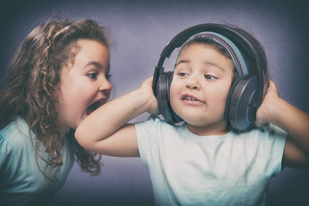 Cheerful kids with headphones - Foto, Imagen
