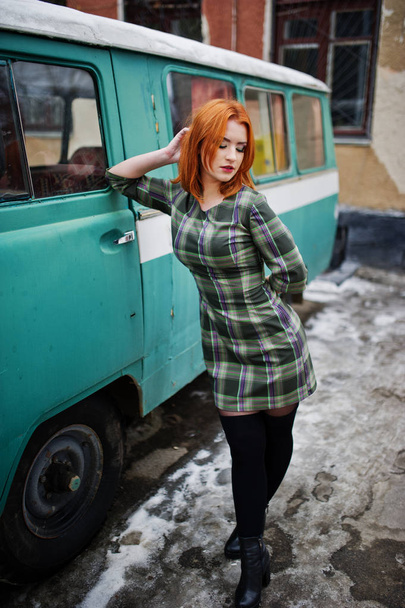 Young red haired girl posed on checkered dress background old re - Zdjęcie, obraz