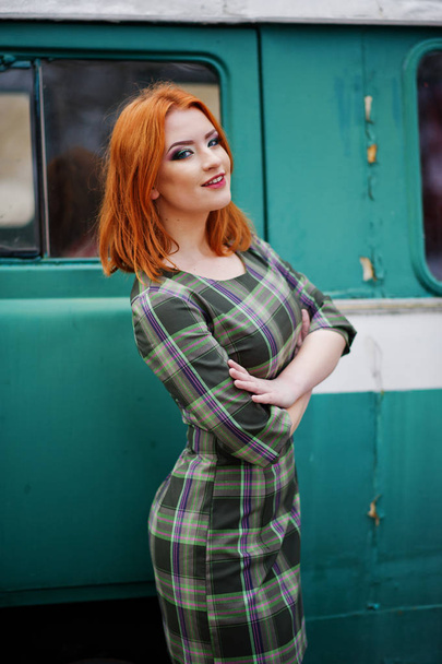 Young red haired girl posed on checkered dress background old re - Fotó, kép