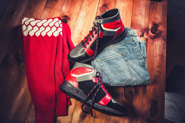 Red men's shoes on a wooden background - 写真・画像