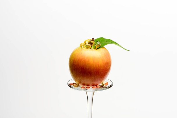 apple on wineglass with pills and capsule - Fotografie, Obrázek