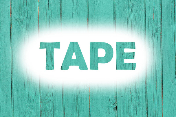 tape word print on the grunge wooden plate - Foto, Bild