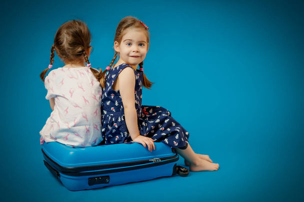 hermanas en una maleta esperando el viaje
 - Foto, Imagen