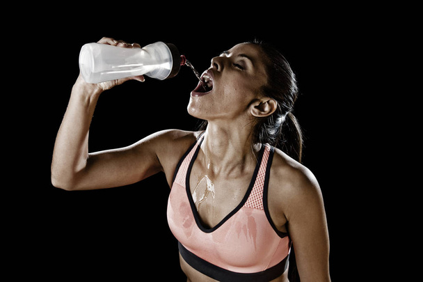 beautiful and fit latin sport woman drinking water tired during - Photo, Image