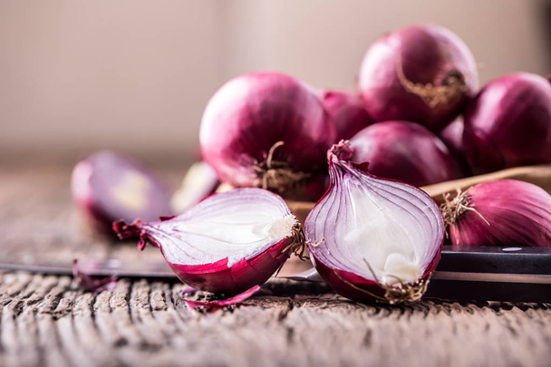 Onion. Red onions on very old oak wood board. Selective focus - Zdjęcie, obraz