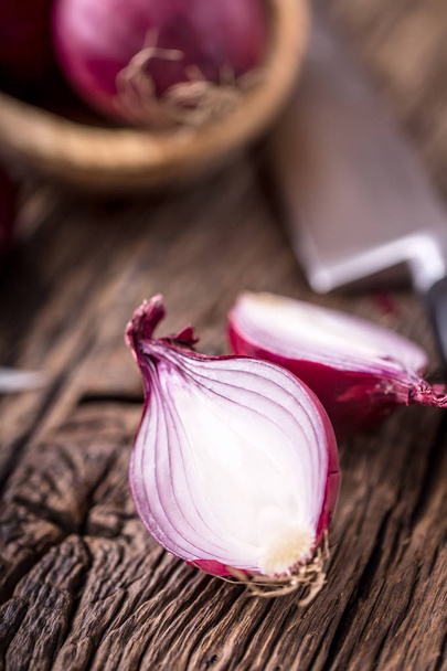 Onion. Red onions on very old oak wood board. Selective focus - Foto, afbeelding