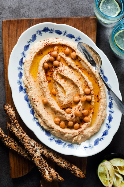 Healthy Homemade Creamy Hummus with Olive Oil  and breadsticks w - Fotografie, Obrázek
