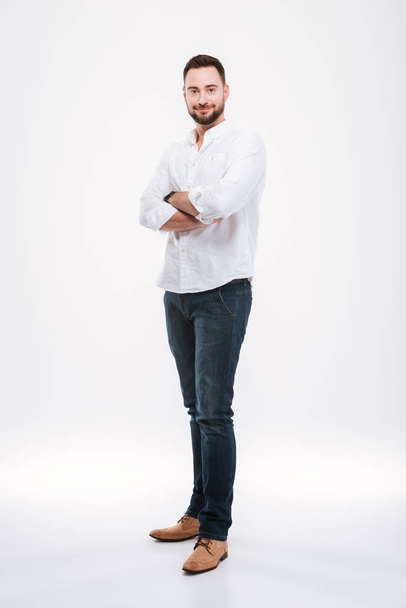 Handsome young bearded man isolated over white background. - 写真・画像
