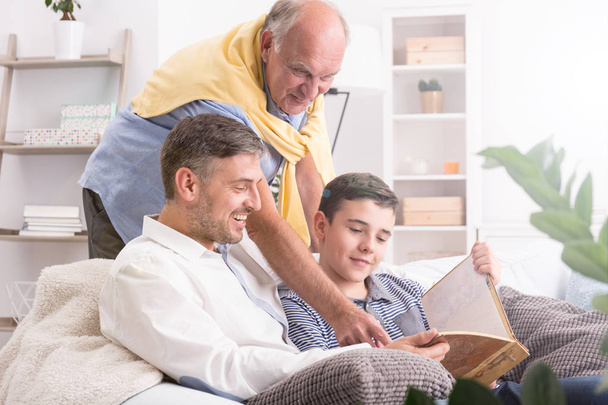 Father watching photos with son - Photo, Image