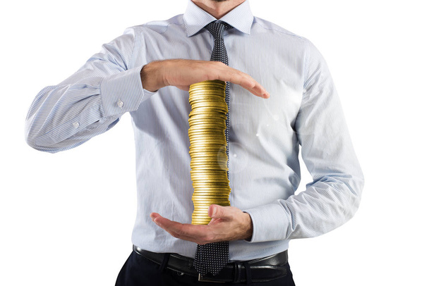Бизнесмен держит стопку монет
 - Фото, изображение