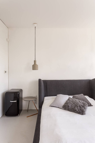 Bedroom with bed and compact fridge - Foto, Bild