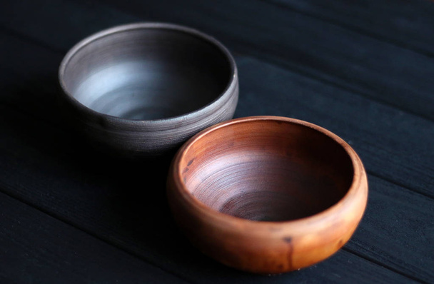 Ceramic bowls on wooden background - Fotografie, Obrázek
