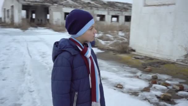 Um rapaz está perto de uma quinta desmoronada
 - Filmagem, Vídeo
