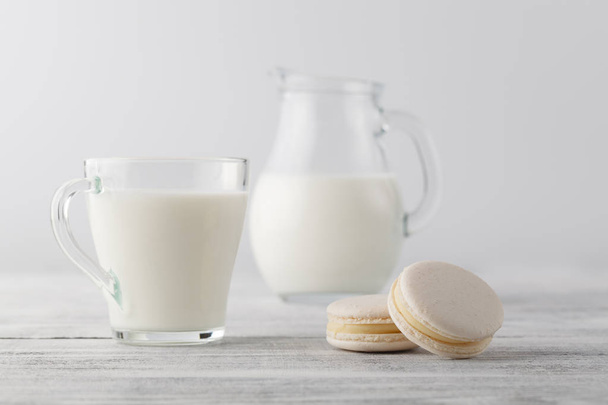 Jug of milk and cup with macaroons - Fotó, kép