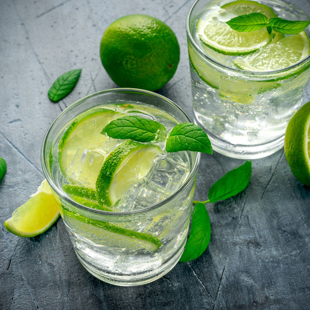 Detox water with green lime mint in glass cup - Photo, Image