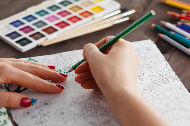 adult woman relieving stress by painting coloring book for relax - Photo, Image