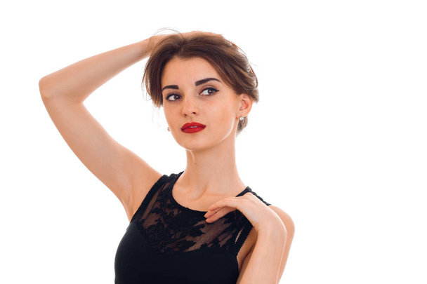 stylish young woman with red lips in black dress looking away isolated on white background - Φωτογραφία, εικόνα