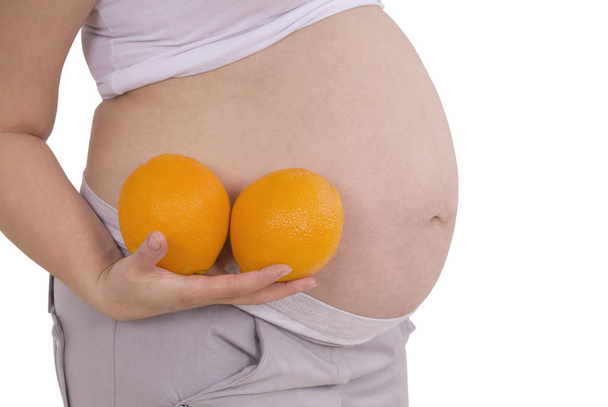 Pregnant woman with orange (Clipping path) - Photo, Image
