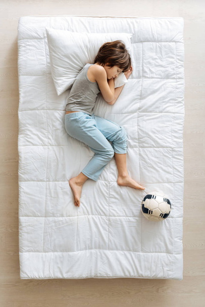 Serene young boy dreaming about football - Φωτογραφία, εικόνα
