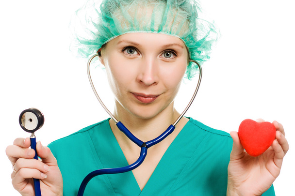 Woman doctor with stethoscope and heart in hands - Fotoğraf, Görsel
