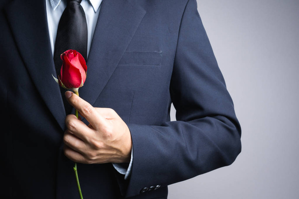 Business man hand with red rose flower - Foto, Imagem