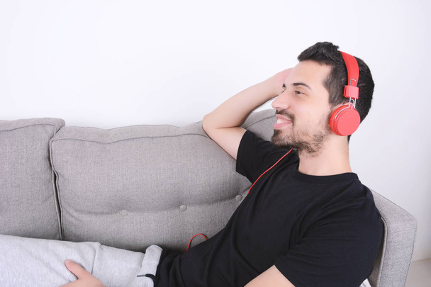 Man listening music on couch. - Valokuva, kuva