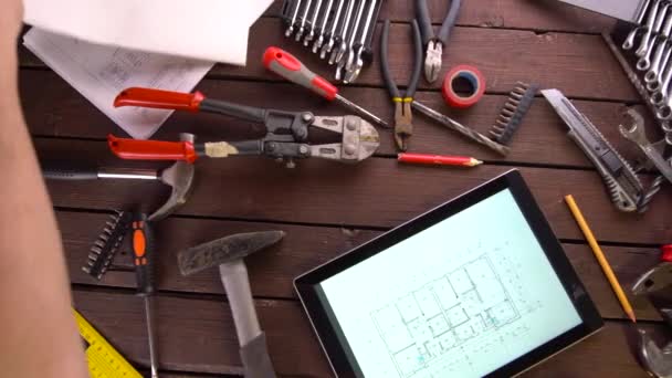 Mechanic engineer works with tablet on his desk - Felvétel, videó