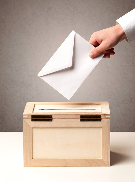 Ballot box with person casting vote  - 写真・画像