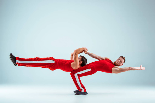 The two gymnastic acrobatic caucasian men on balance pose - Zdjęcie, obraz