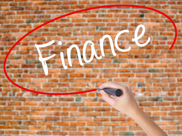 Woman Hand Writing Finance with black marker on visual screen. - Photo, image